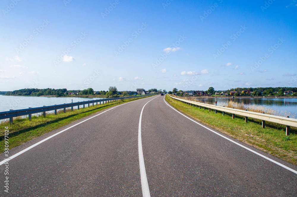 A beautiful automobile asphalt road without cars and people.