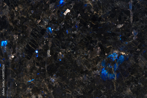 Texture of natural black labradorite stone. Natural blue mineral stone labradorite crystal in the rock. High resolution photo.   photo