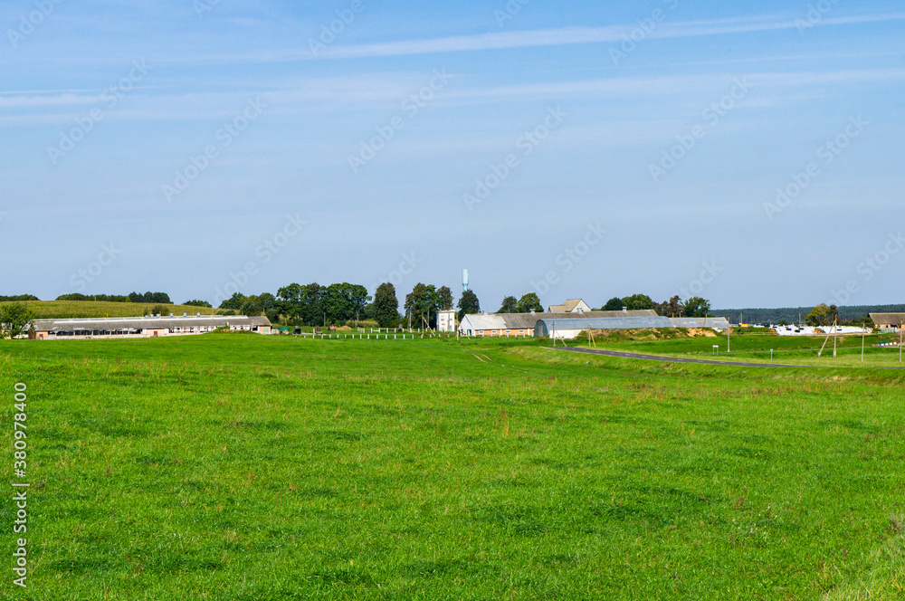 Rural view of a farm in the fields on the horizon Rural view of a farm in the fields on the horizon