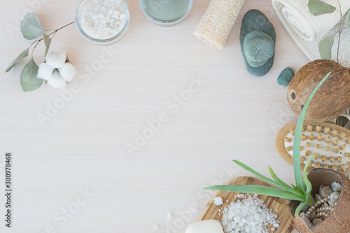 Beauty and fashion concept with spa setting. composition with Dead sea salt, coconut, natural cosmetic blue clay, soda, loofah. Flat lay, Spa concept with cotton flower, stones and towel.