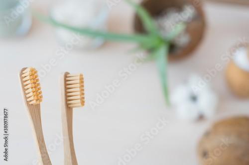 Oral care with natural cosmetics and baboo toothbrush. Flat lay spa composition with aloe vera and candles on wooden background. copy space. Beautiful medical homemade cosmetic products concept