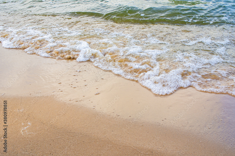 Transparent sea wave on a clean sandy seashoreа Transparent sea wave on a clean sandy seashoreа