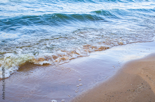 Transparent sea wave on a clean sandy seashoreа