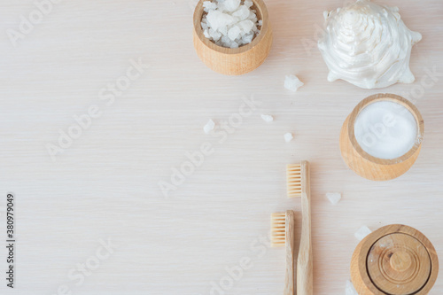  Oral care with natural cosmetics and baboo toothbrush. Flat lay spa composition with aloe vera and candles on wooden background. copy space. Beautiful medical homemade cosmetic products concept