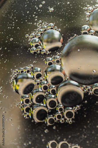 Small bubbles of vegetable oil in water close-up.