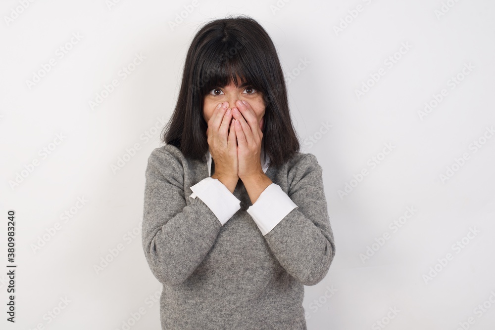 Vivacious Young businesswoman with retro short hairdo wearing casual clothes standing over isolated white background, giggles joyfully, covers mouth, has fun alone, has natural laughter, Vivacious Young businesswoman with retro short hairdo wearing casual clothes standing over isolated white background, giggles joyfully, covers mouth, has fun alone, has natural laughter,