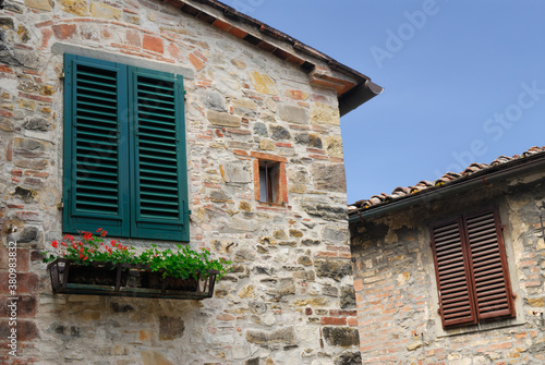 Stone buildings and shuttered windows in San Donato in Poggio Tuscany Italy