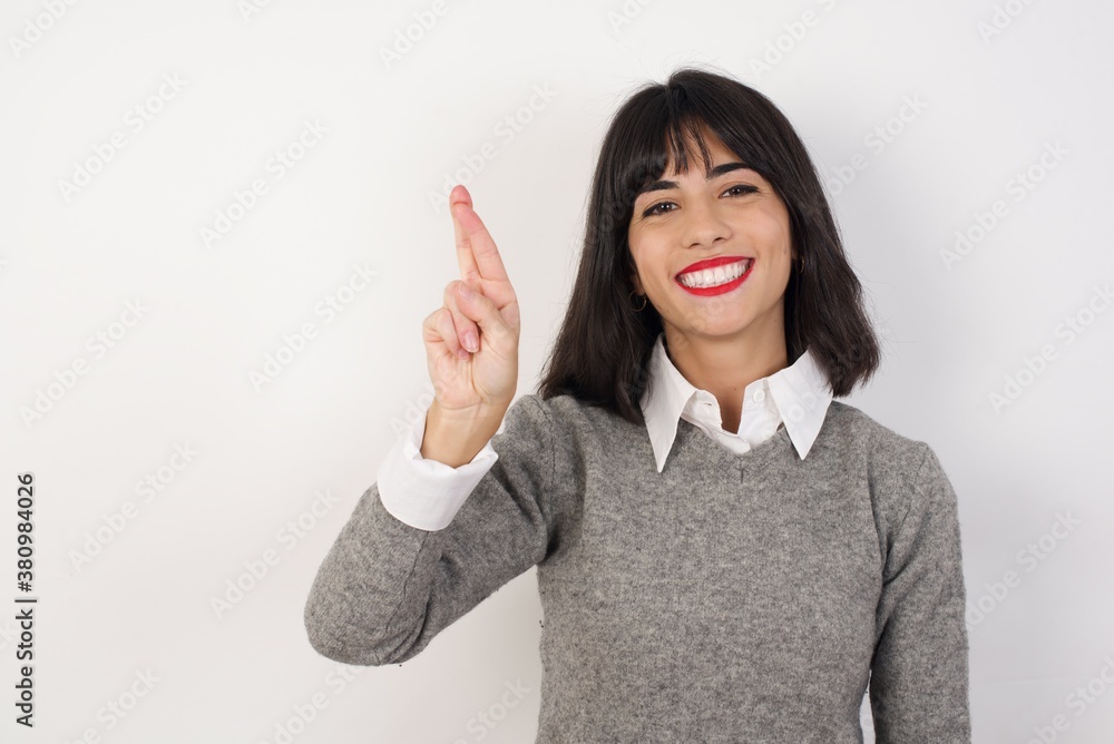 Young businesswoman with retro short hairdo wearing casual clothes standing over isolated white background pointing up with fingers number ten in Chinese sign language Shi Young businesswoman with retro short hairdo wearing casual clothes standing over isolated white background pointing up with fingers number ten in Chinese sign language Shi