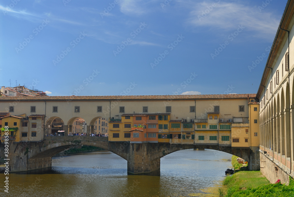 Old shops hanging on the Ponte Vecchio bridge over the Arno river in Florence