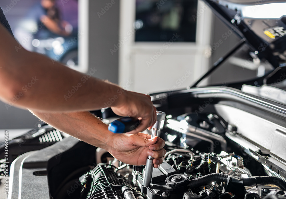 Auto mechanic working and repair on car engine in mechanics garage. Car service. Auto mechanic working and repair on car engine in mechanics garage. Car service.