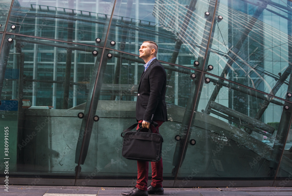 Photo of a young and attractive business man wearing smart clothes with a briefcase ready to start his work day Photo of a young and attractive business man wearing smart clothes with a briefcase ready to start his work day