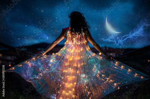 Fényképezés Belly dancer with wings of light under a starry sky