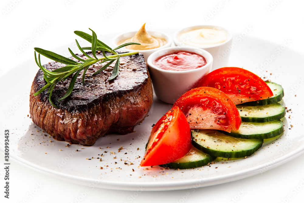 Barbecue beef steak with fresh tomatoes and cucumbers, mustard, mayonnaise and ketchup on white background
Barbecue beef steak with fresh tomatoes and cucumbers, mustard, mayonnaise and ketchup on white background