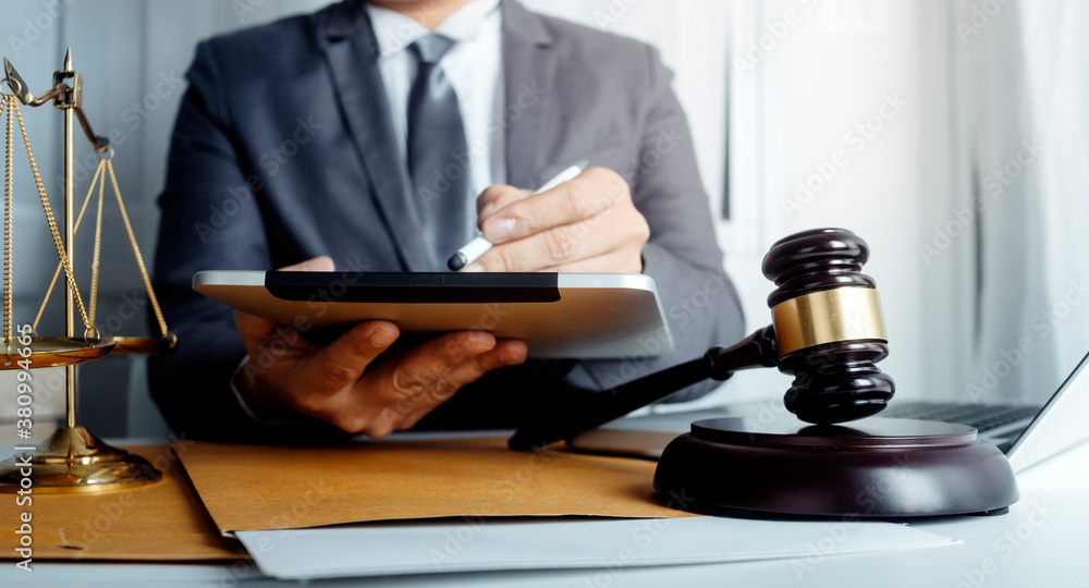 Business and lawyers discussing contract papers with brass scale on desk in office. Law, legal services, advice, justice and law concept picture with film grain effect Business and lawyers discussing contract papers with brass scale on desk in office. Law, legal services, advice, justice and law concept picture with film grain effect