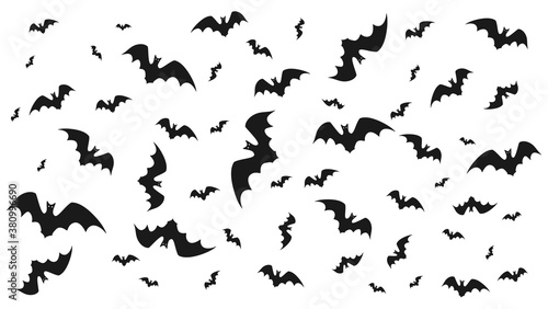 Vector illustration of flying bats on a light background.  Symbol of Halloween and fear.