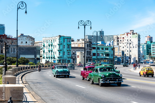 Vintage classic cars driving on the outskirts of Havana Cuba