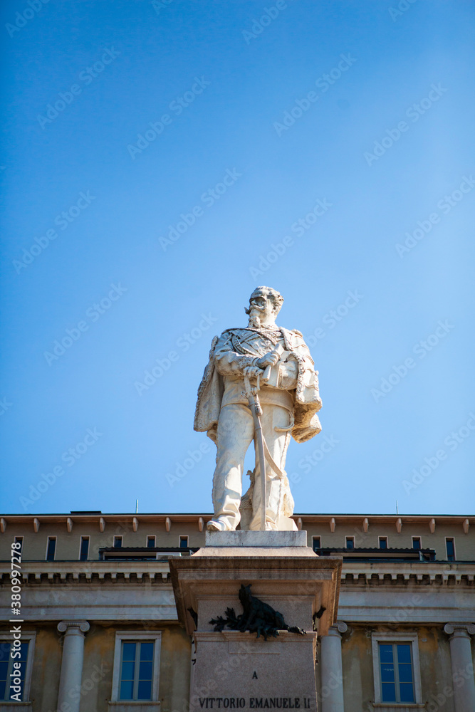 The monument of Vittorio Emanuele II in Bergamo, Lombardy, Italy. The statue is made of white marble in the Lower City (Città Bassa) in front of the city hall. European architecture.