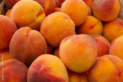 Beautiful yellow-red ripe peaches in a box.