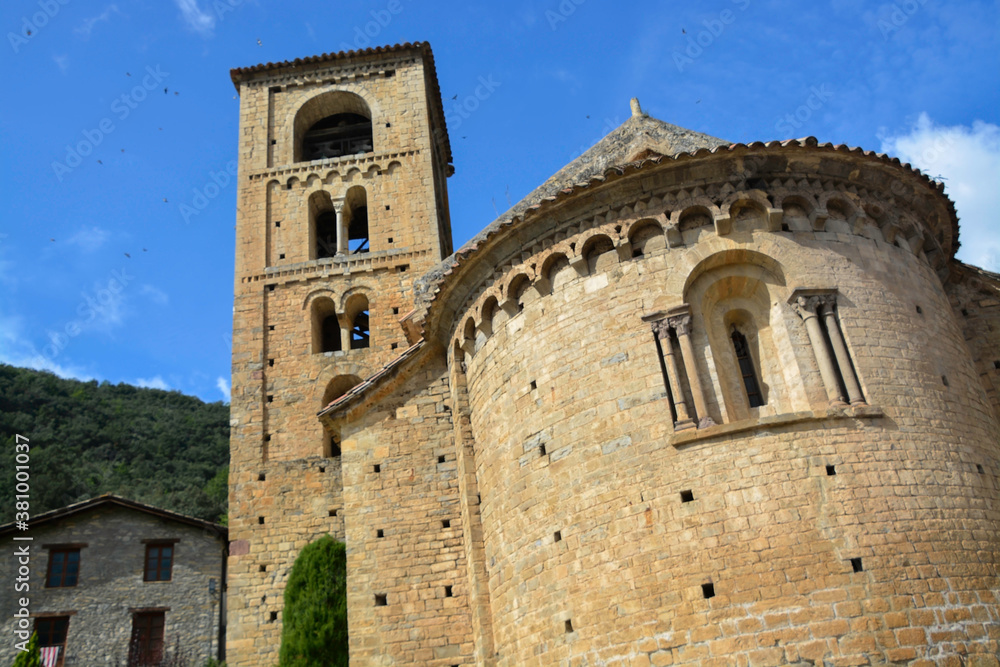 BEGET, CATALONIA, SPAIN, EUROPE, SEPTEMBER 2020. Fantastic Romanesque church of Saint Christopher or San Cristóbal, surrounded by stone houses in the beautiful medieval town of Beget.