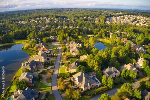 Photography Beautiful aerial view of a sub division with golf course and a beautiful lake  in suburbs of Atlanta during golden hour