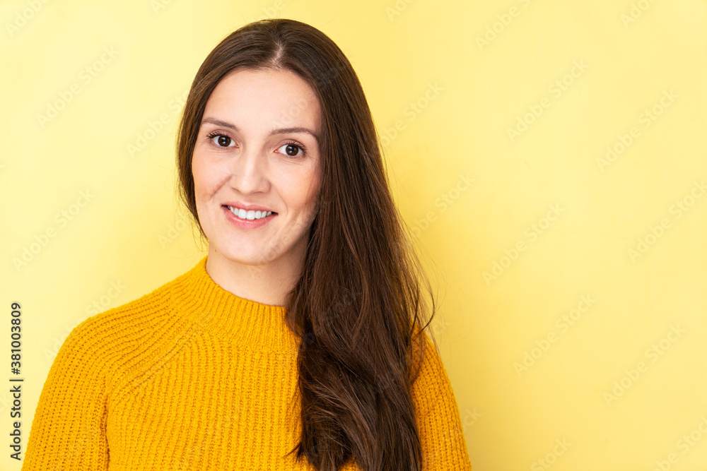 Obraz premium Happy attractive tatar young woman smiling and laughing isolated on yellow background with copy space, face portrait
