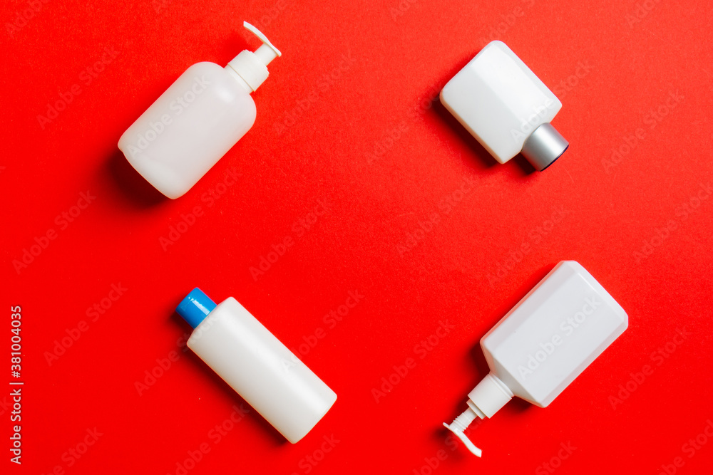 Set of White Cosmetic containers isolated on colored background, top view with copy space. Group of plastic bodycare bottle containers with empty space for you design Set of White Cosmetic containers isolated on colored background, top view with copy space. Group of plastic bodycare bottle containers with empty space for you design