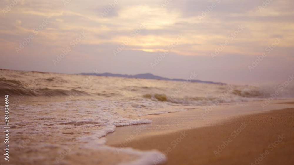 Sea surface with small waves against the backdrop of sunrise of sun slow motion. Large disk of sun rises above sea, solar path on water. Golden light of sea panorama. Relax