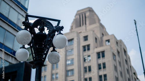 Classical Lamppost With a Tall Building in the Background photo