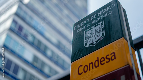 A Condesa Neighborhood Sign With the Latinamerican Tower in the Back photo