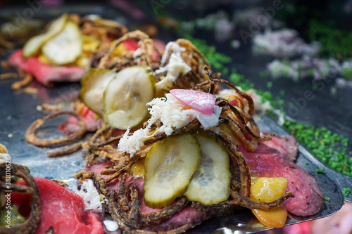 Roast beef, pickle, and horseradish smorrebrod open faced sandwiches in Copenhagen, Denmark photo