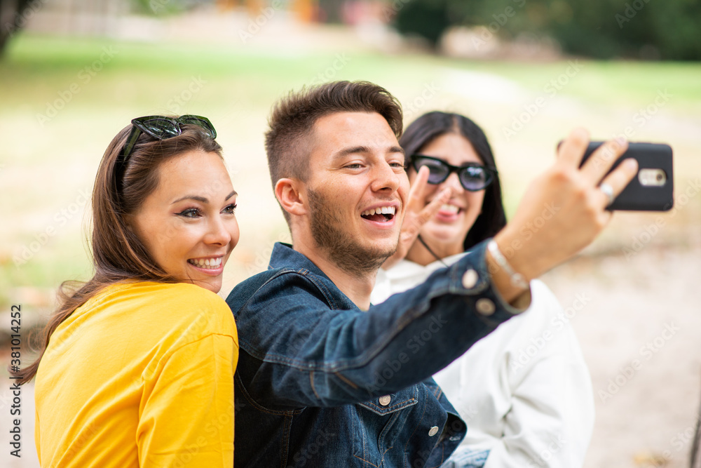 Group of happy friends taking a selfie together