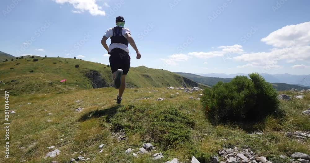 Trail running athlete running on the mountain ridge fast. Endurance and competition race. Trail running athlete running on the mountain ridge fast. Endurance and competition race.