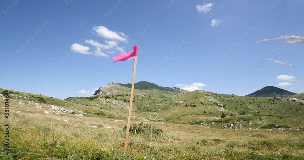 Flag for trail running race. Flag in the mountain for keeping runners on the track. Flag for trail running race. Flag in the mountain for keeping runners on the track.