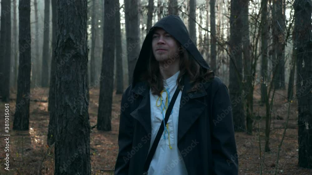 Monk Prayer. Wanderer Pilgrim in Black Cloak with Cowl Praying in Misty Wood. Autumn Morning. 2x Slow motion 60 fps 4K Monk Prayer. Wanderer Pilgrim in Black Cloak with Cowl Praying in Misty Wood. Autumn Morning. 2x Slow motion 60 fps 4K