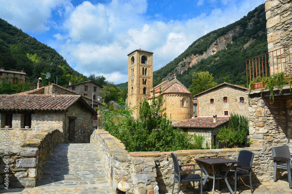 BEGET, CATALONIA, SPAIN, EUROPE, SEPTEMBER 2020. Fantastic Romanesque church of Saint Christopher or San Cristóbal, surrounded by stone houses in the beautiful medieval town of Beget