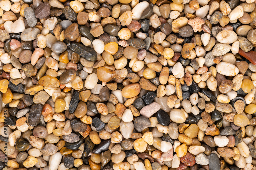 Multi-colored small river stones texture and background. Multi-colored small river stones texture and background.
