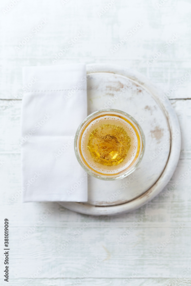 Glass of beer on bright wooden background. Top view. Copy space. Glass of beer on bright wooden background. Top view. Copy space.