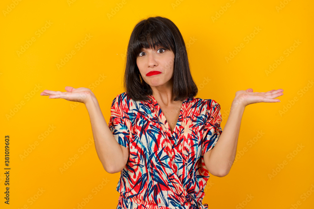 Puzzled and clueless young woman with arms out, shrugging her shoulders, saying: who cares, so what, I don't know. Negative human emotions, facial expressions, life perception and attitude Puzzled and clueless young woman with arms out, shrugging her shoulders, saying: who cares, so what, I don't know. Negative human emotions, facial expressions, life perception and attitude