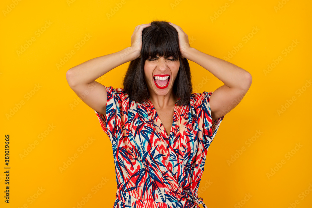 Shocked panic Caucasian girl dressed in stylish clothing holding hands on head and screaming in despair and frustration while being late for plane, her eyes full of terror, mouth dropped open Shocked panic Caucasian girl dressed in stylish clothing holding hands on head and screaming in despair and frustration while being late for plane, her eyes full of terror, mouth dropped open