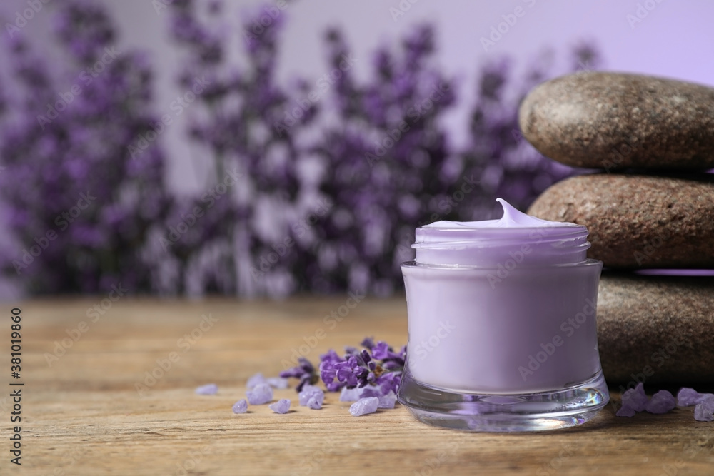 Stones, jar of cream and lavender flowers on wooden table. Space for text Stones, jar of cream and lavender flowers on wooden table. Space for text