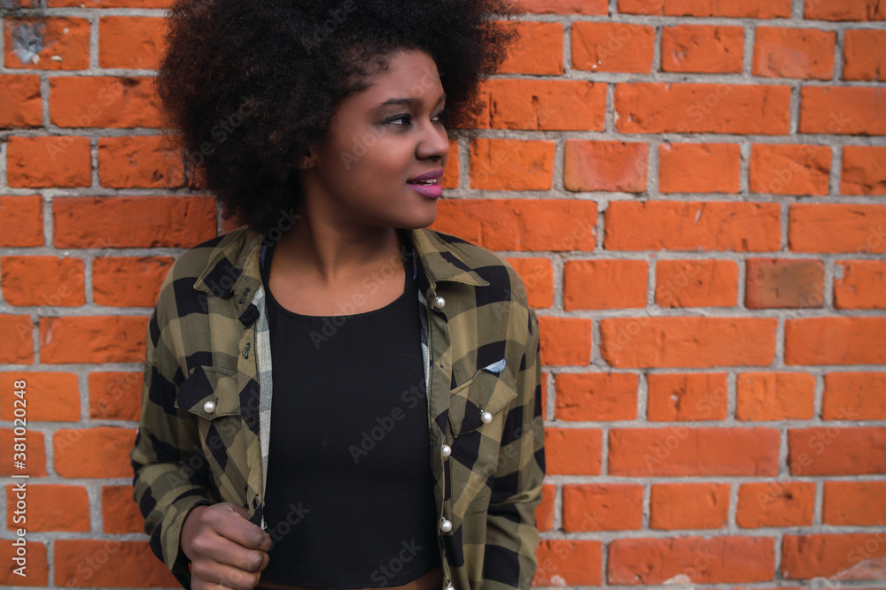 Afro american latin woman against brick wall. Afro american latin woman against brick wall.