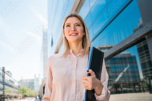 Wallpaper Mural Business woman standing outside office buildings. Torontodigital.ca