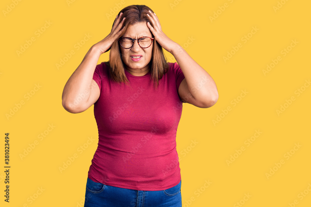 Middle age latin woman wearing casual clothes and glasses suffering from headache desperate and stressed because pain and migraine. hands on head. Middle age latin woman wearing casual clothes and glasses suffering from headache desperate and stressed because pain and migraine. hands on head.