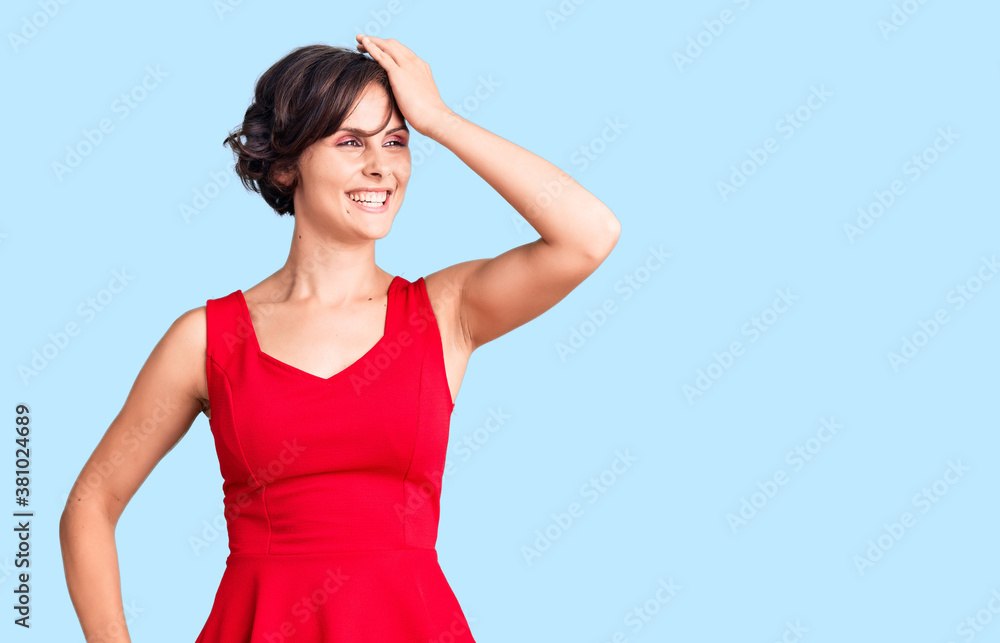 Beautiful young woman with short hair wearing casual style with sleeveless shirt smiling confident touching hair with hand up gesture, posing attractive and fashionable Beautiful young woman with short hair wearing casual style with sleeveless shirt smiling confident touching hair with hand up gesture, posing attractive and fashionable