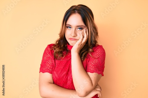 Young beautiful caucasian woman wearing casual clothes thinking looking tired and bored with depression problems with crossed arms.