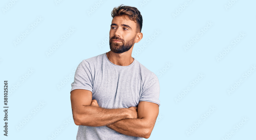 Young hispanic man wearing casual clothes looking to the side with arms crossed convinced and confident Young hispanic man wearing casual clothes looking to the side with arms crossed convinced and confident
