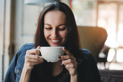 Girl drinking fresh hot drink in cafe