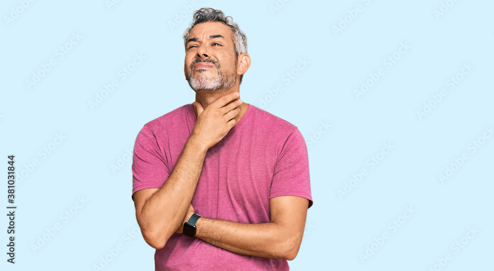 Middle age grey-haired man wearing casual clothes touching painful neck, sore throat for flu, clod and infection Middle age grey-haired man wearing casual clothes touching painful neck, sore throat for flu, clod and infection