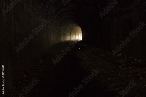 Dark road in a tunnel to the light