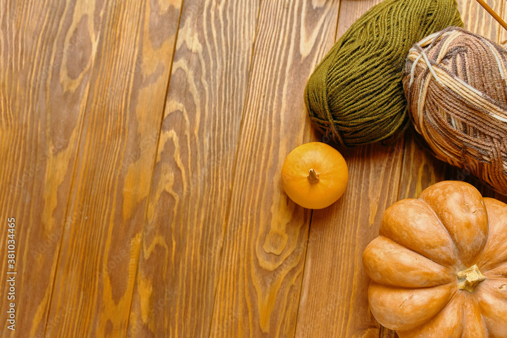 Pumpkin and knitting on the wooden table. Pumpkin and knitting on the wooden table.